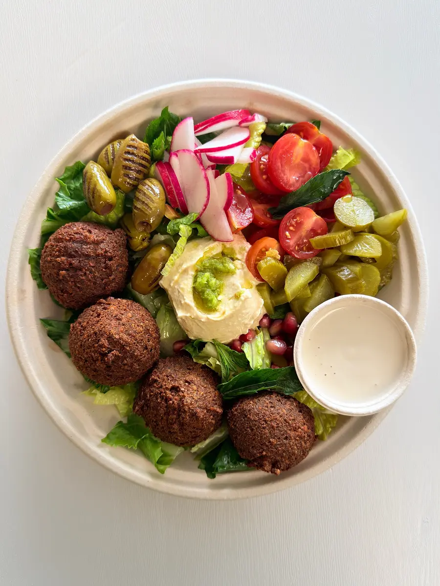House falafel bowl with hummus, radishes and lemon tahini at Fil Fil Mediterranean in Homer Glen, IL.