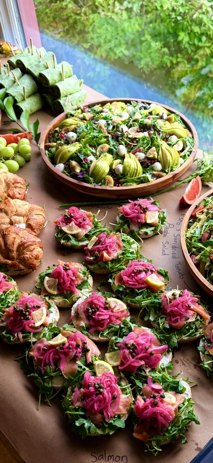 Noosh Catering spread with pesto and sundried tomato pasta salad and smoked salmon crostini.