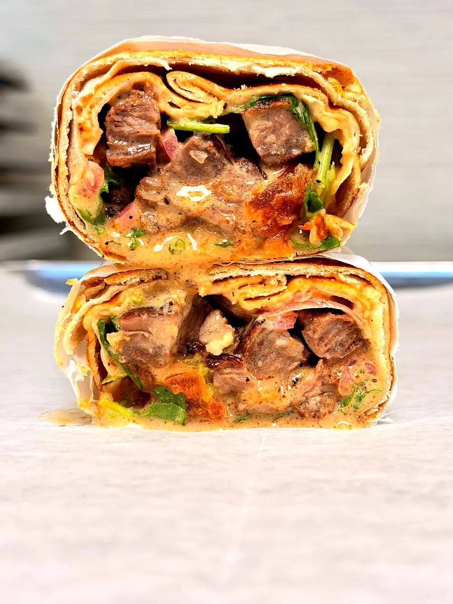 Grilled skirt steak wrap with fire-roasted tomatoes and green chili salsa at Fil Fil Mediterranean in Homer Glen, IL.