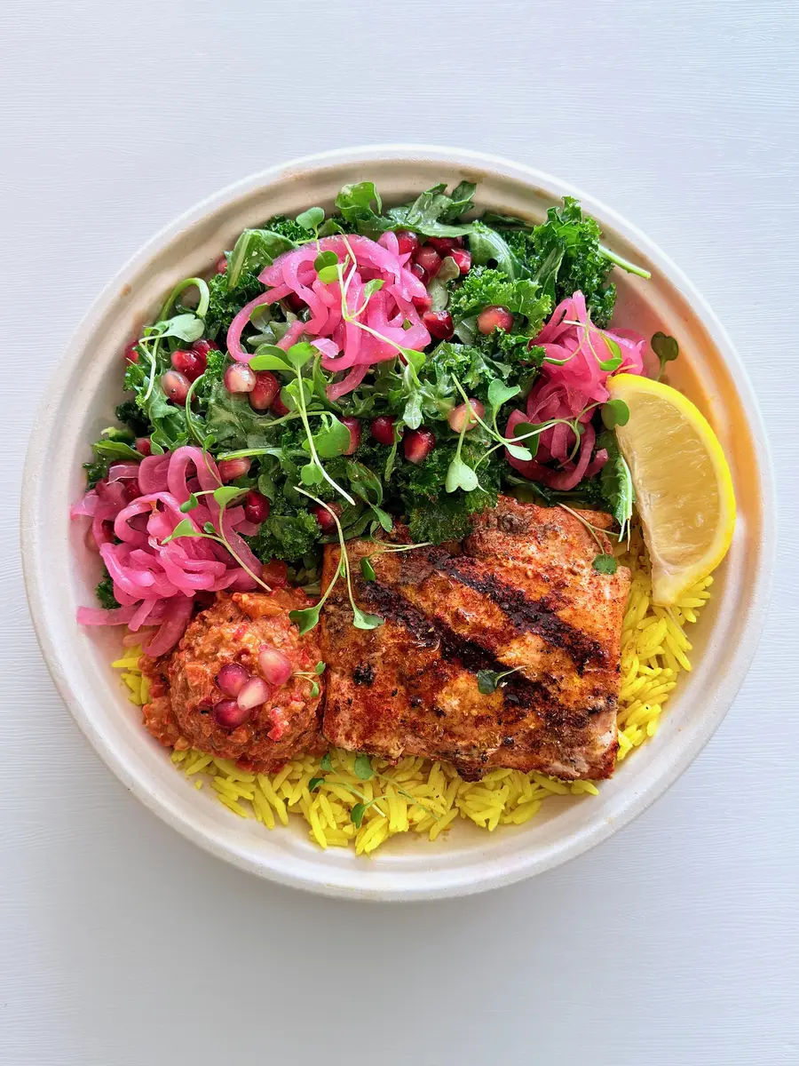 Wild salmon bowl with cracked wheat burghul, kale and pomegranate at Fil Fil Mediterranean in Homer Glen, IL.